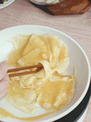 油6成熱時(shí)，下雞蛋液，邊緣凝固時(shí)翻拌成塊狀。