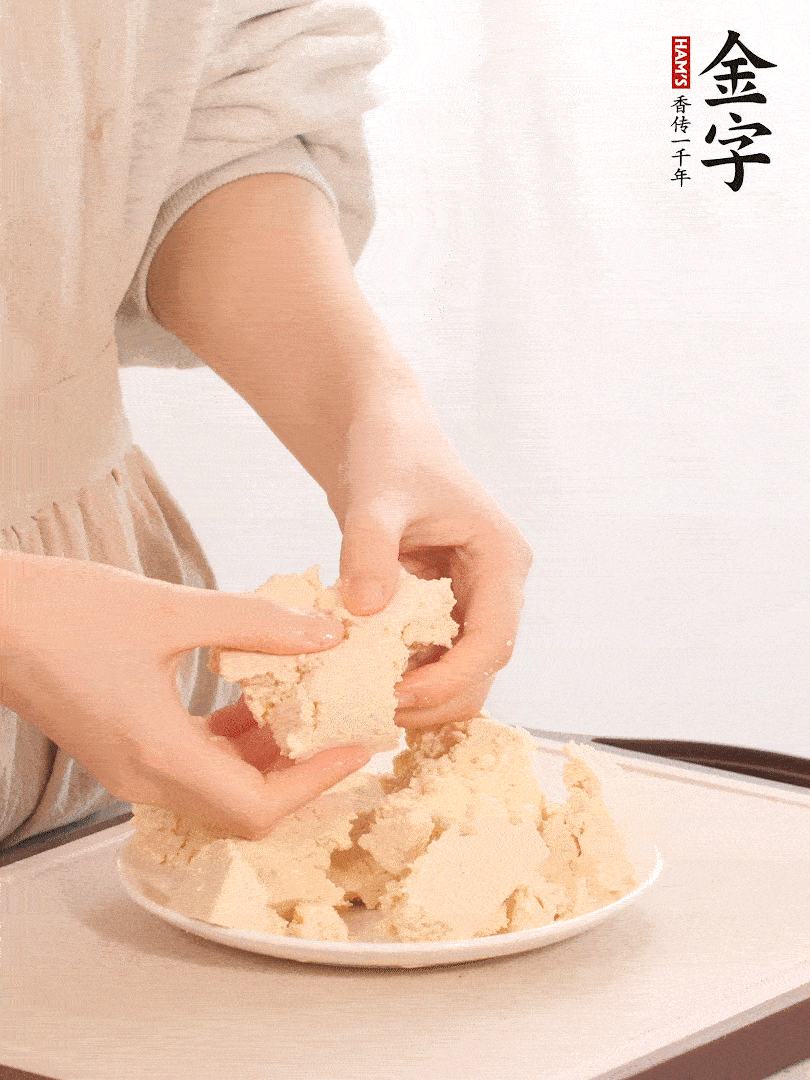 老豆腐用手掰成塊。